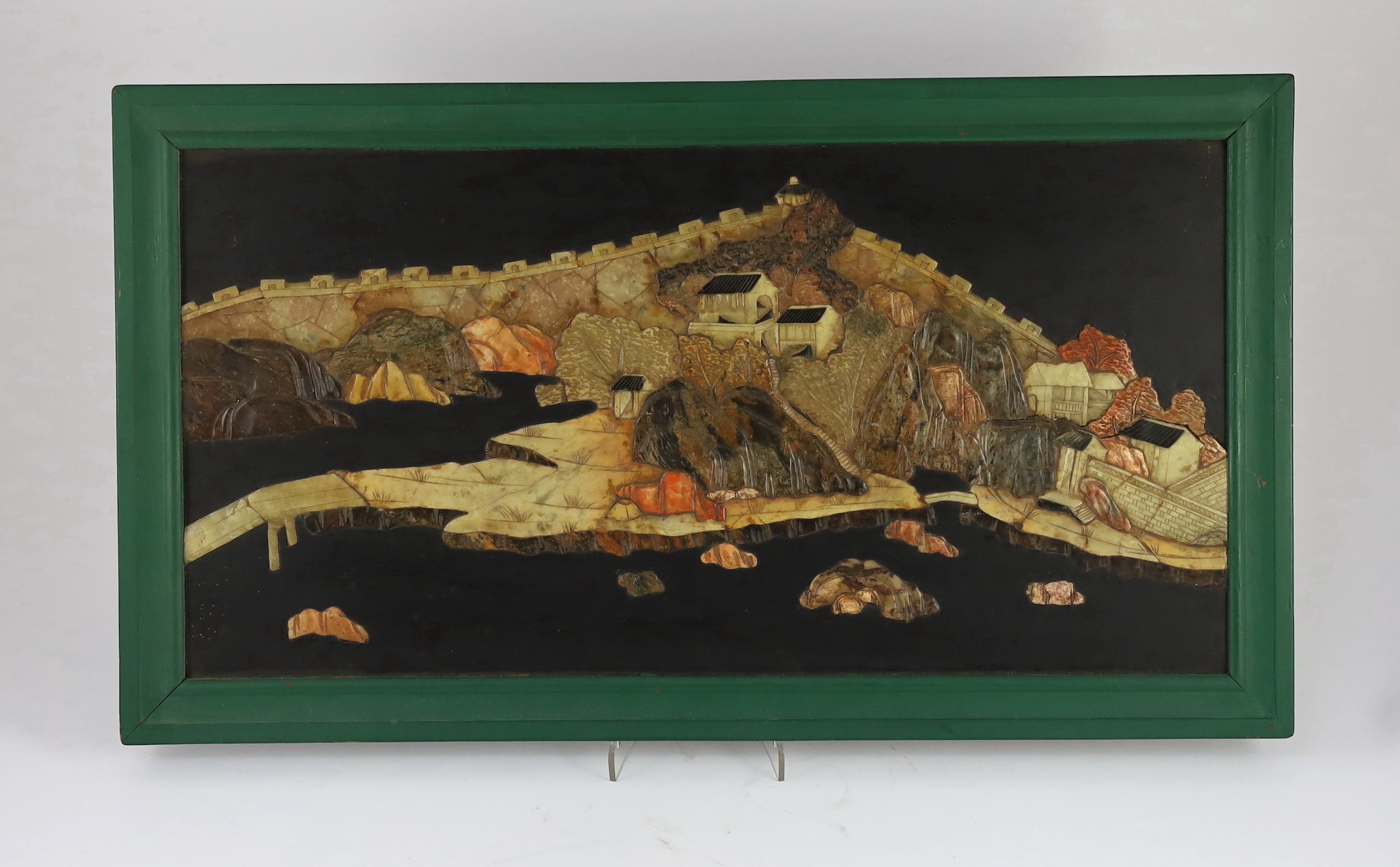 A pair of Chinese soapstone overlaid landscape panels, early 20th century, each panel including frame 33.5cm x 59cm